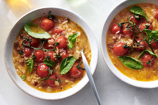 Brothy Tomato Rice Soup. Let late-season tomatoes shine by simmering them whole, vines and all, Eric Kim writes. Food Stylist: Simon Andrews. (David Malosh/The New York Times)