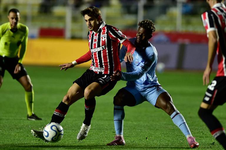 O meio-campista Bobadilla, do São Paulo, protege a bola do atacante Asprilla, do Bolívar, no estádio Hernando Siles, em La Paz - Jorge Bernal/AFP · Jorge Bernal/AFP