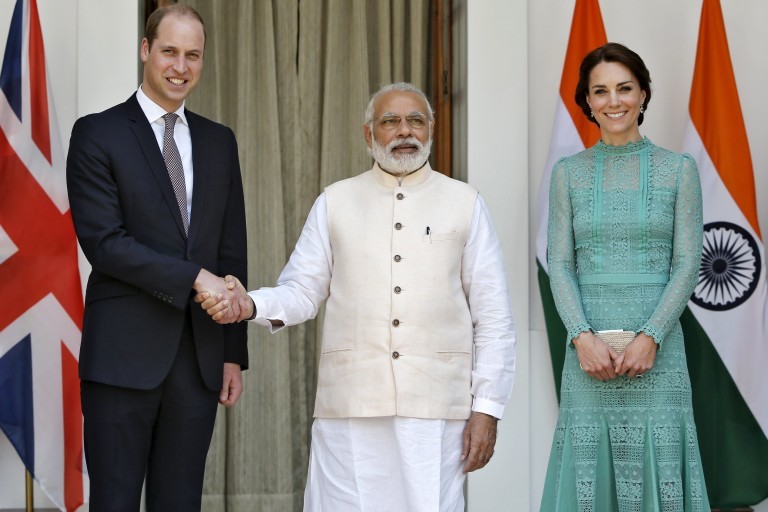 Britain's Prince William shakes hands with India's PM Modi as Catherine, Duchess of Cambridge, smiles during a photo opportunity at Hyderabad House in New Delhi